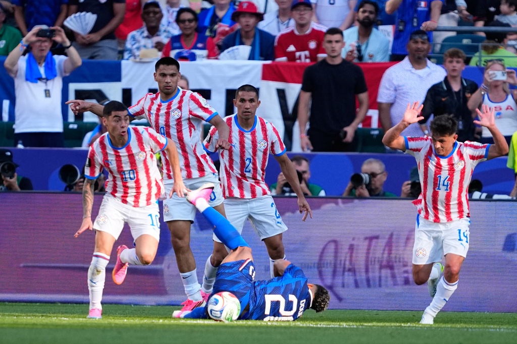 Paraguay's Miguel Almiron (10) controls the ball as France's Desire Doue falls during the World Cup round of 16 soccer match in Philadelphia, Saturday, July 4, 2026. (AP Photo/Petr David Josek)