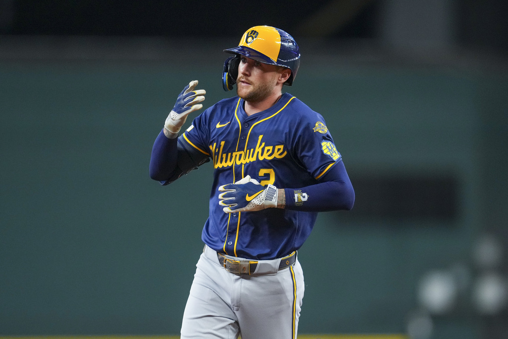 Milwaukee Brewers' Brice Turang reacts after hitting a leadoff home run off Texas Rangers starting pitcher Merrill Kelly during the first inning of a baseball game Wednesday, Sept. 10, 2025, in Arlington, Texas. (AP Photo/Julio Cortez)