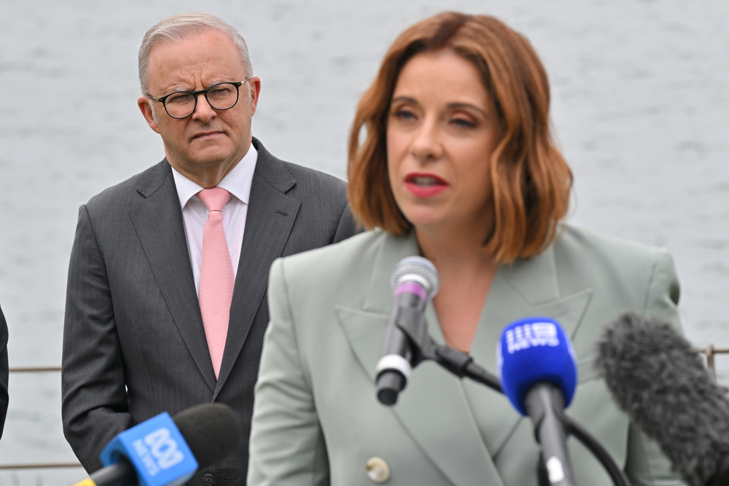 Australian Prime Minister Anthony Albanese watches as Minister for Communications Anika Wells speaks at an event to mark the beginning of the social media ban for children under 16 years of age, at Kirribilli House in Sydney, Australia, Wednesday, Dec. 10, 2025. (Mick Tsikas/AAP Image via AP)