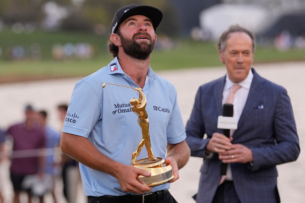 Cameron Young holds the The Players Championship Trophy after winning the final round of The Players Championship golf tournament, Sunday, March 15, 2026, in Ponte Vedra Beach, Fla. (AP Photo/Gerald Herbert)