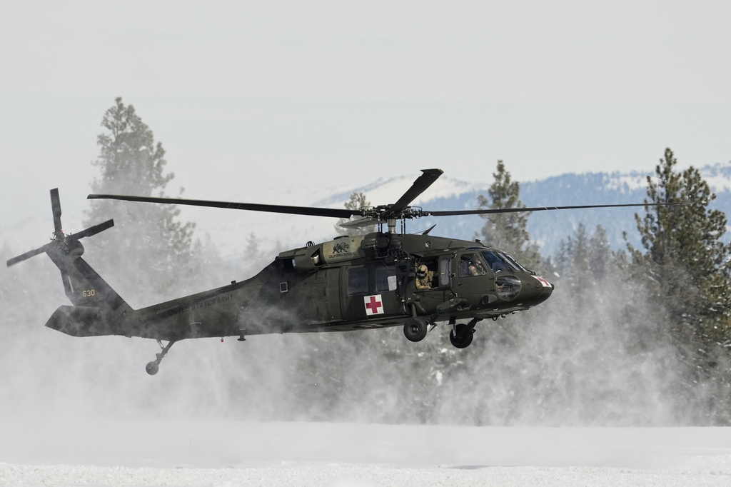 FILE - A U.S. Army Blackhawk helicopter lands at Truckee Tahoe Airport in Truckee, Calif., Feb. 21, 2026, while aiding in recovery efforts for a group of skiers who went missing during a deadly avalanche. (AP Photo/Godofredo A. Vásquez, File)