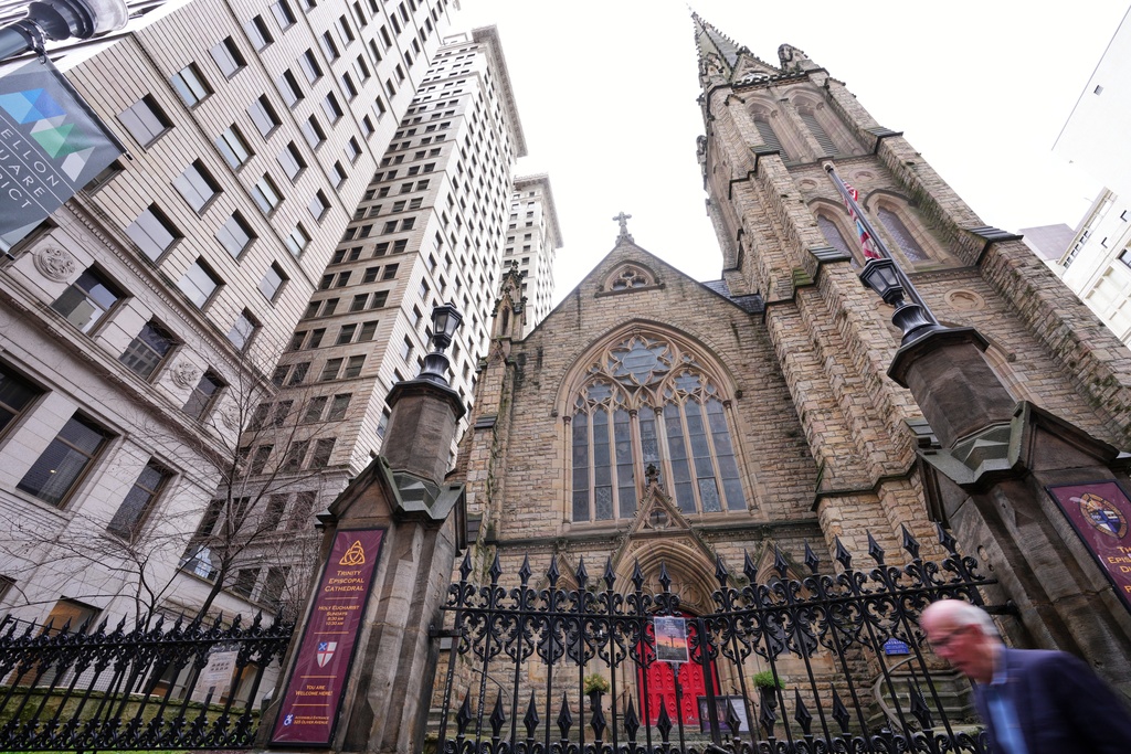 A man walks past Trinity Episcopal Cathedral in downtown Pittsburgh, Wednesday, March 11, 2026. (AP Photo/Gene J. Puskar)