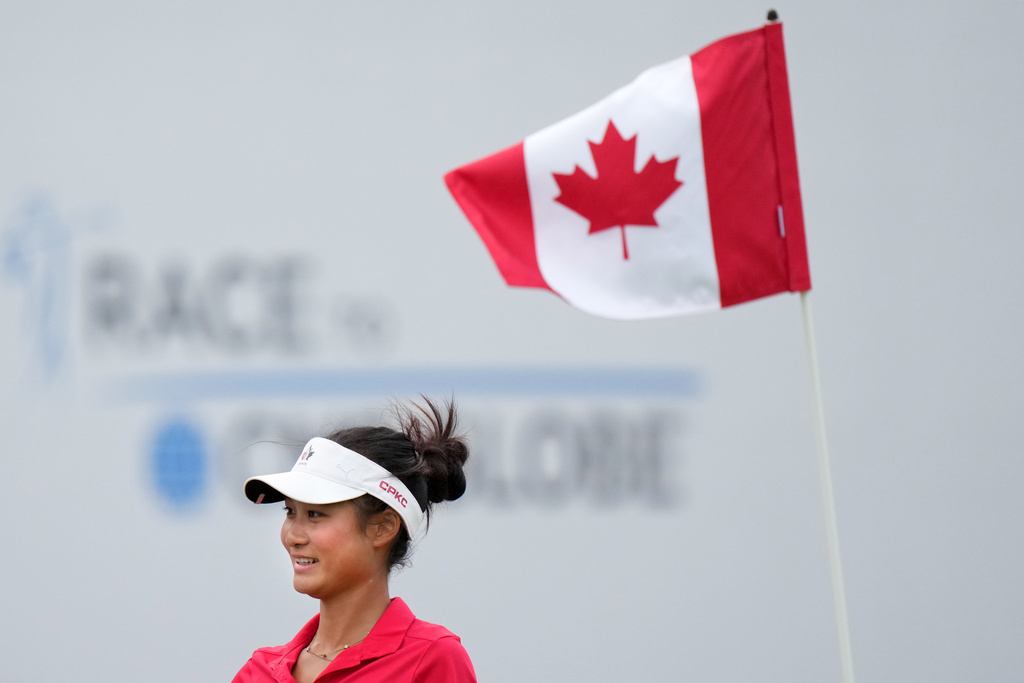 Aphrodite Deng, of Canada, smiles after making birdie on the 18th hole during the final round at the LPGA Canadian Women's Open golf tournament in Edmonton, Alberta, Sunday, Aug. 23, 2026. (Darryl Dyck/The Canadian Press via AP)