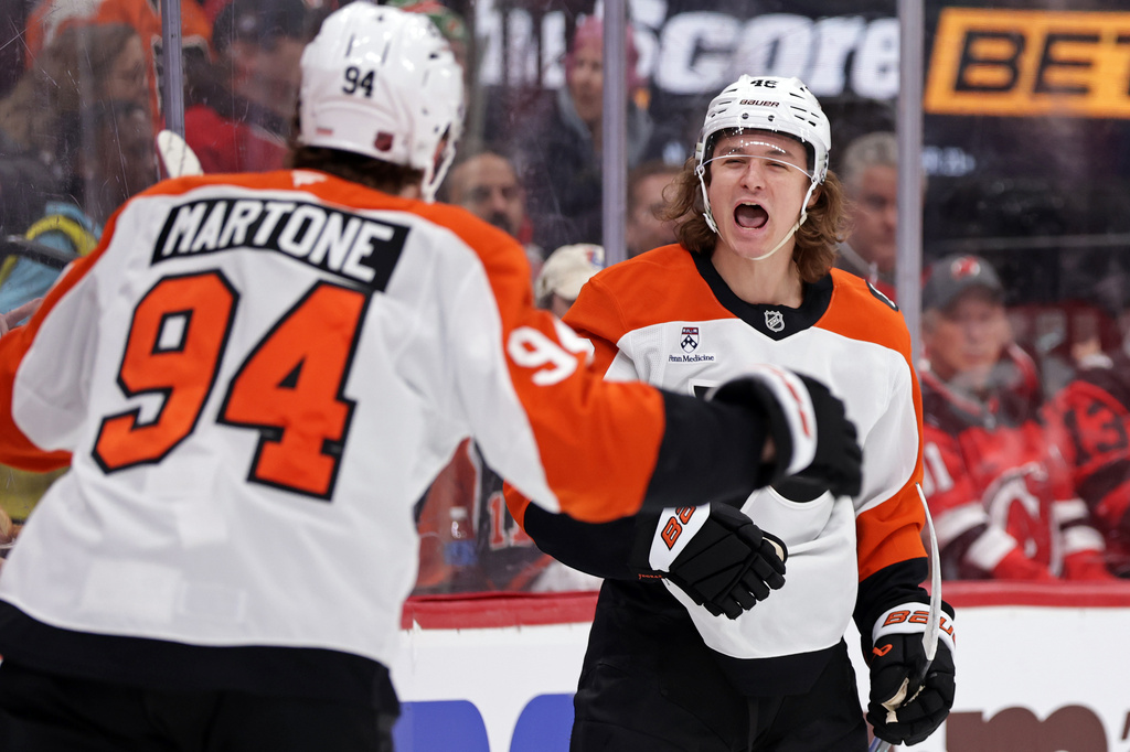 Philadelphia Flyers center Trevor Zegras (46) is congratulated by Porter Martone after scoring his second goal of the game during the first period of an NHL hockey game against the New Jersey Devils, Tuesday, April 7, 2026, in Newark, N.J. (AP Photo/Adam Hunger)