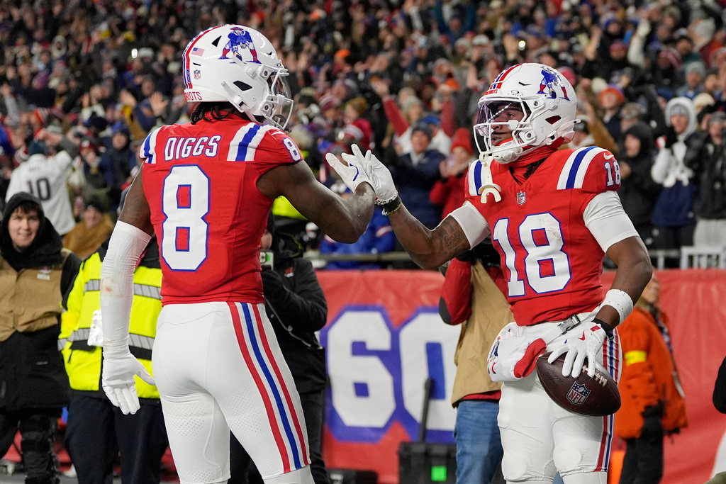 New England Patriots wide receiver Kyle Williams (18) celebrates with teammate Stefon Diggs (8) after a touchdown reception against the New York Giants during the first half of an NFL football game Monday, Dec. 1, 2025, in Foxborough, Mass. (AP Photo/Charles Krupa)