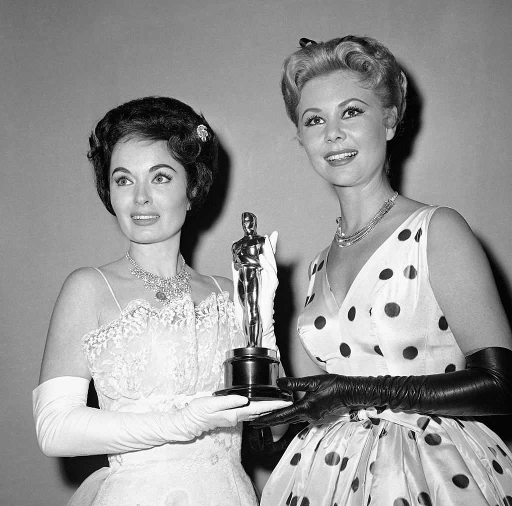 FILE - Ann Blyth, left, and Mitzi Gaynor hold an Oscar presented by the Motion Picture Academy for the best short subjects documentary, in Hollywood, Calif., April 4, 1960. (AP Photo, File)