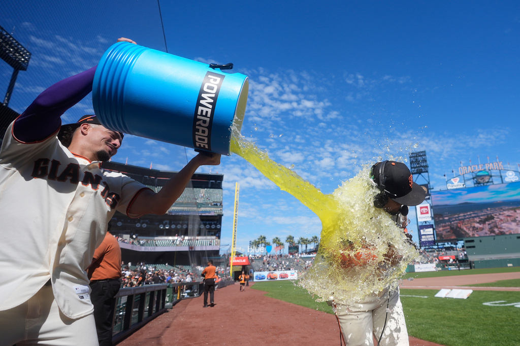 San Francisco Giants' Luis Arraez, right, is doused by Willy Adames after a baseball game against the Philadelphia Phillies in San Francisco, Wednesday, April 8, 2026. (AP Photo/Jeff Chiu)
