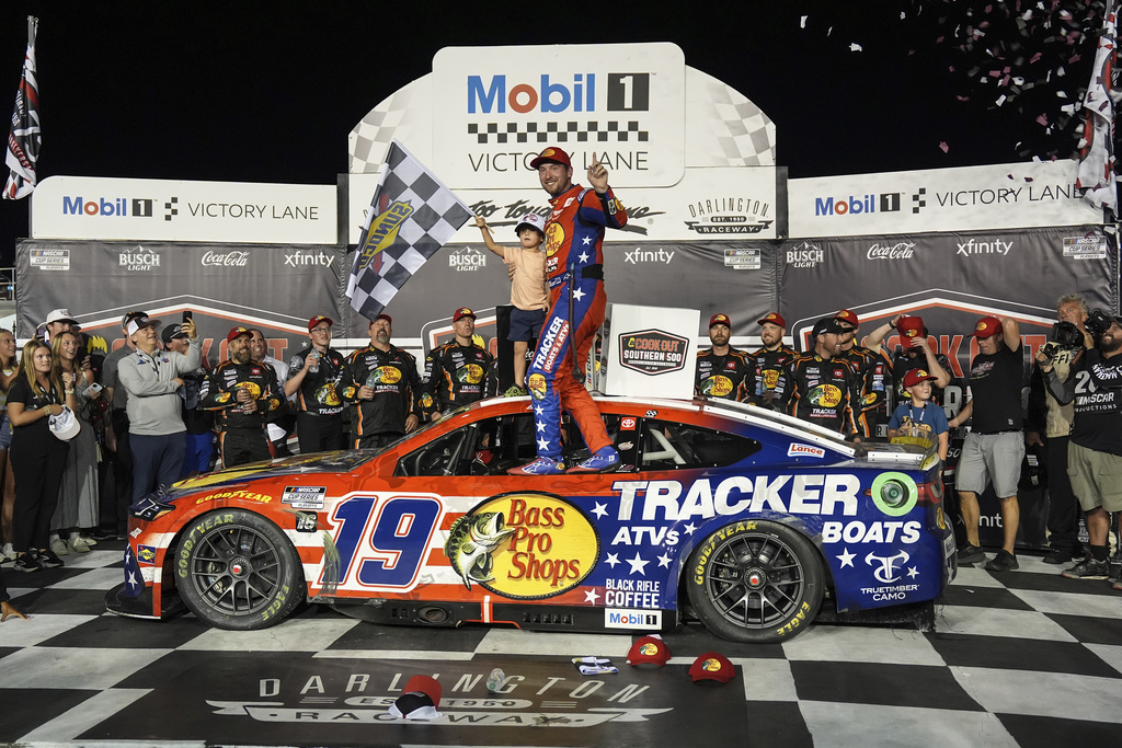 Chase Briscoe, center, celebrates with his son Brooks in Victory Lane after winning a NASCAR Cup Series auto race at Darlington Raceway, Sunday, Aug. 31, 2025, in Darlington, S.C. (AP Photo/Matt Kelley)