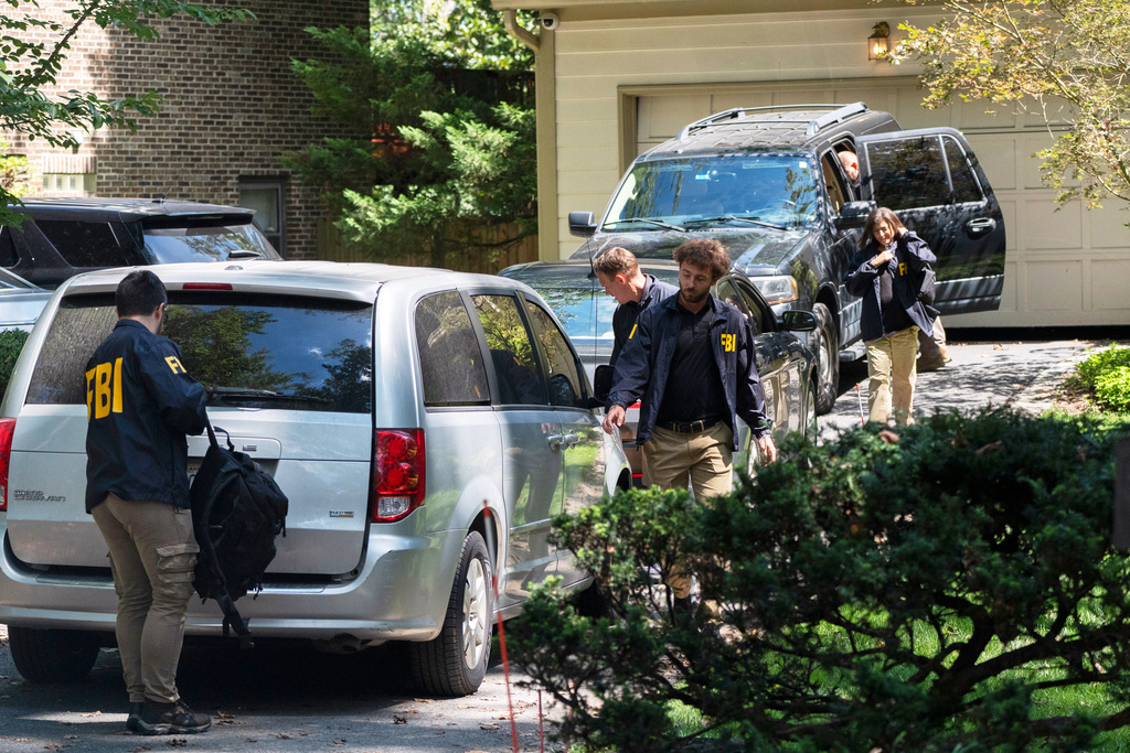 A group of FBI agents leave former national security adviser John Bolton's house where FBI searched the home, Friday, Aug. 22, 2025, in Bethesda, Md. (AP Photo/Manuel Balce Ceneta)