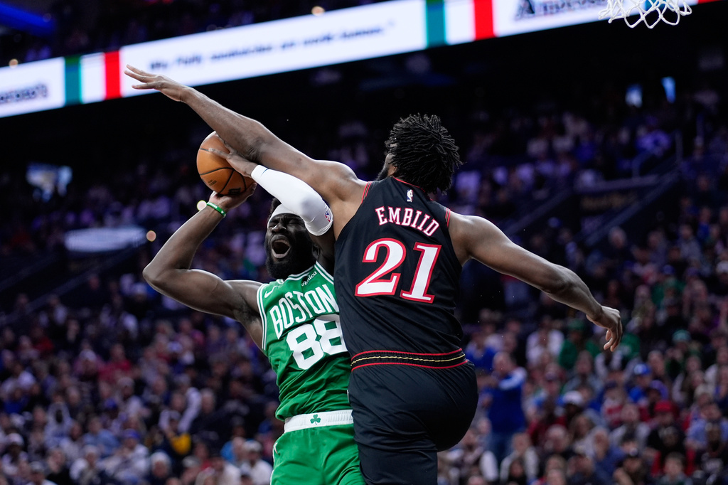 Boston Celtics' Neemias Queta, left, cannot get a shot past Philadelphia 76ers' Joel Embiid during the first half of Game 4 in a first-round NBA basketball playoffs series Sunday, April 26, 2026, in Philadelphia. (AP Photo/Matt Slocum)