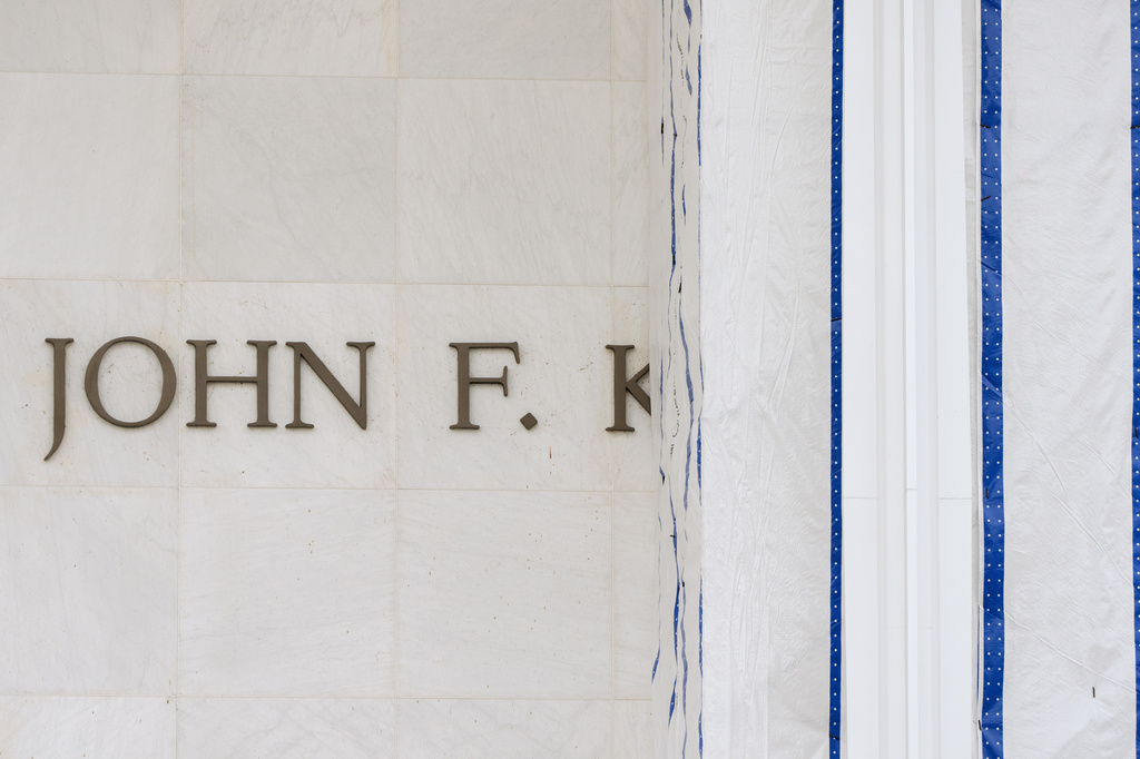 The John F. Kennedy Center for the Performing Arts is seen as its sign remains covered by a tarp, Friday, June 19, 2026, in Washington. (AP Photo/Mark Schiefelbein)