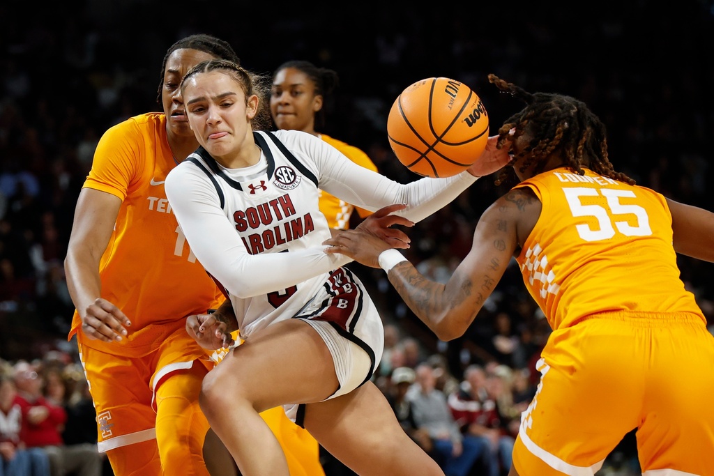 South Carolina guard Tessa Johnson, center, loses control of the ball as she drives between Tennessee forward Zee Spearman, left, and guard Talaysia Cooper during the first half of an NCAA college basketball game in Columbia, S.C., Sunday, Feb. 8, 2026. (AP Photo/Nell Redmond)