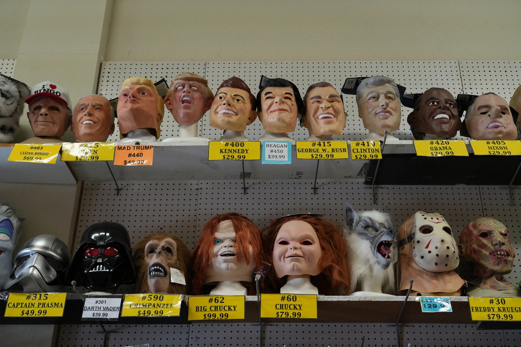 A variety of face masks line the shelves at the House of Humor costume shop in Redwood City, Calif., Thursday, Sept. 18, 2025. (AP Photo/Terry Chea)