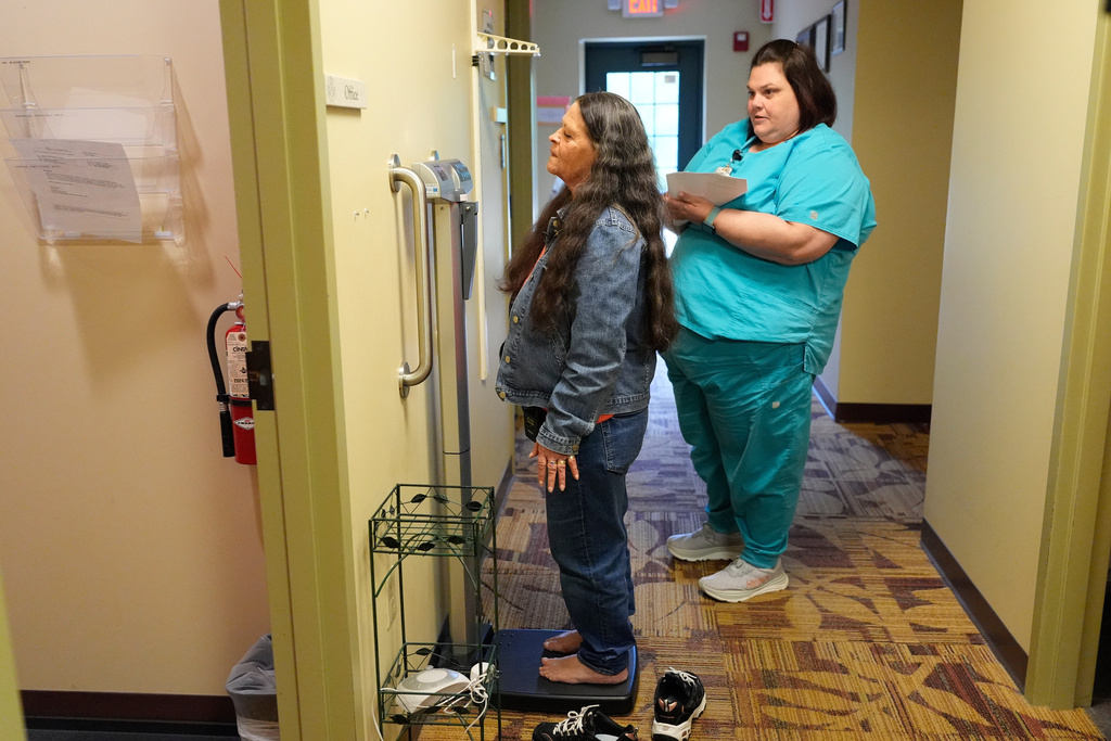 Susan Bushby is weighed during an appointment at Ammonoosuc Community Health Services, Tuesday, Oct. 21, 2025, in Franconia, N.H. (AP Photo/Robert F. Bukaty)