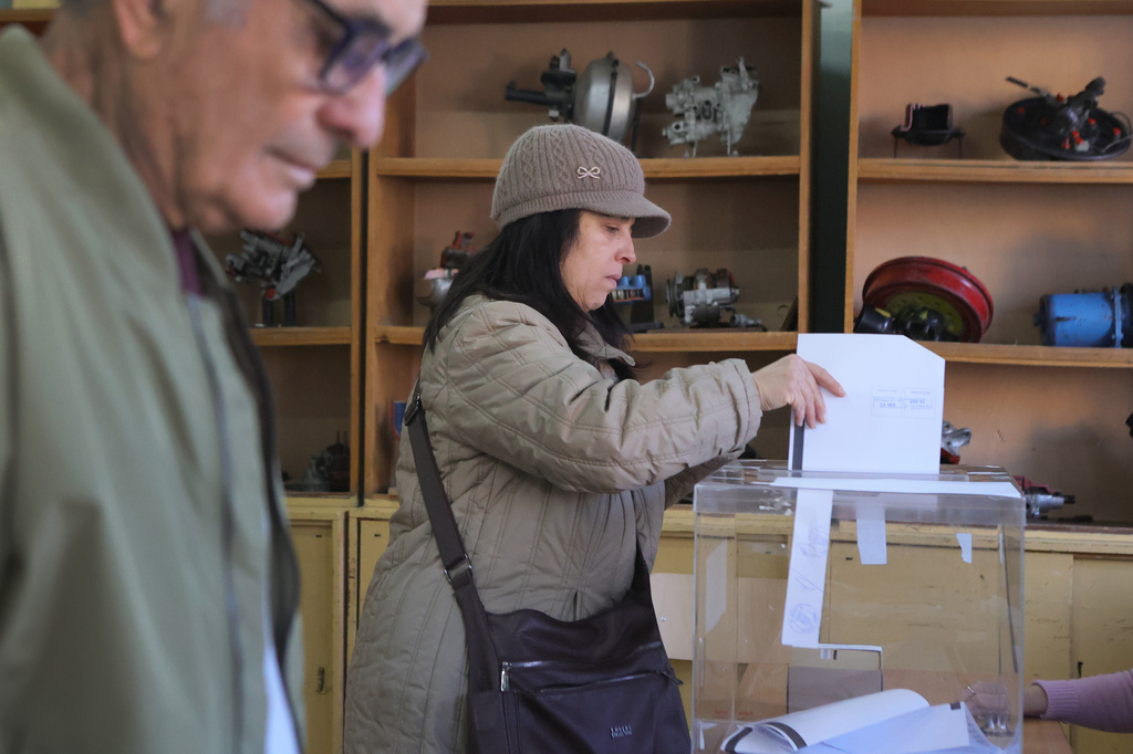 People cast.their ballots at a polling station in Sofia, Bulgaria, Sunday, April 19, 2026, during early parliamentary elections. (AP Photo/Valentina Petrova)