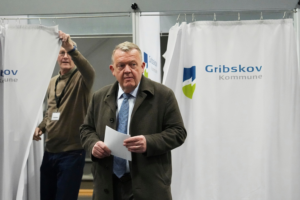 Chairman of the Moderates party and Denmark's Foreign Minister Lars Loekke Rasmussen holds his ballot at a poling station in Græsted, Denmark, on Tuesday, March 24, 2026, during the general election. (AP Photo/Sergei Grits)