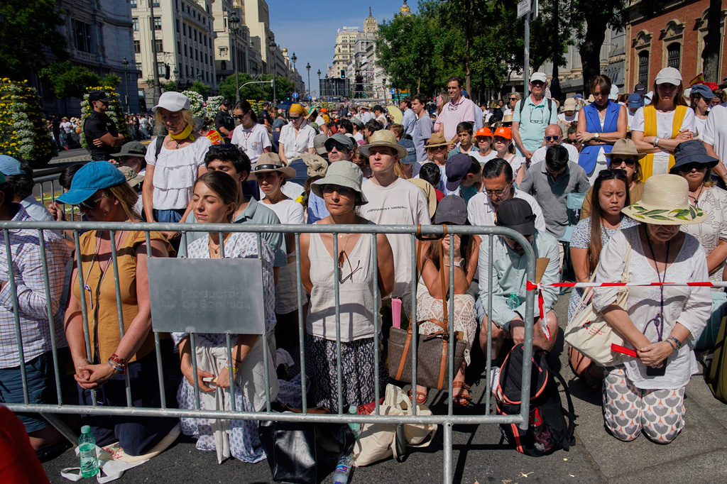 People attend a Mass presided over by Pope Leo XIV, marking the Catholic feast of Corpus Christi at Plaza de Cibeles in Madrid, Spain, Sunday, June 7, 2026, on the second day of his seven-day apostolic visit to mainland Spain and the Canary Islands. (AP Photo/Andrea Comas)