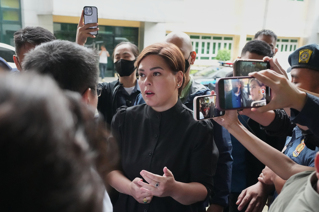 Philippine Vice President Sara Duterte, center, arrives at the Quezon city justice hall Saturday, Sept. 5, 2026 after an arrest warrant was issued on charges that she publicly threatened to have the president and two other people assassinated. (AP Photo/Aaron Favila)