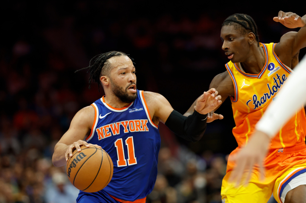 New York Knicks guard Jalen Brunson (11) drives against Charlotte Hornets forward Moussa Diabate, right, during the first half of an NBA basketball game in Charlotte, N.C., Thursday, March 26, 2026. (AP Photo/Nell Redmond)