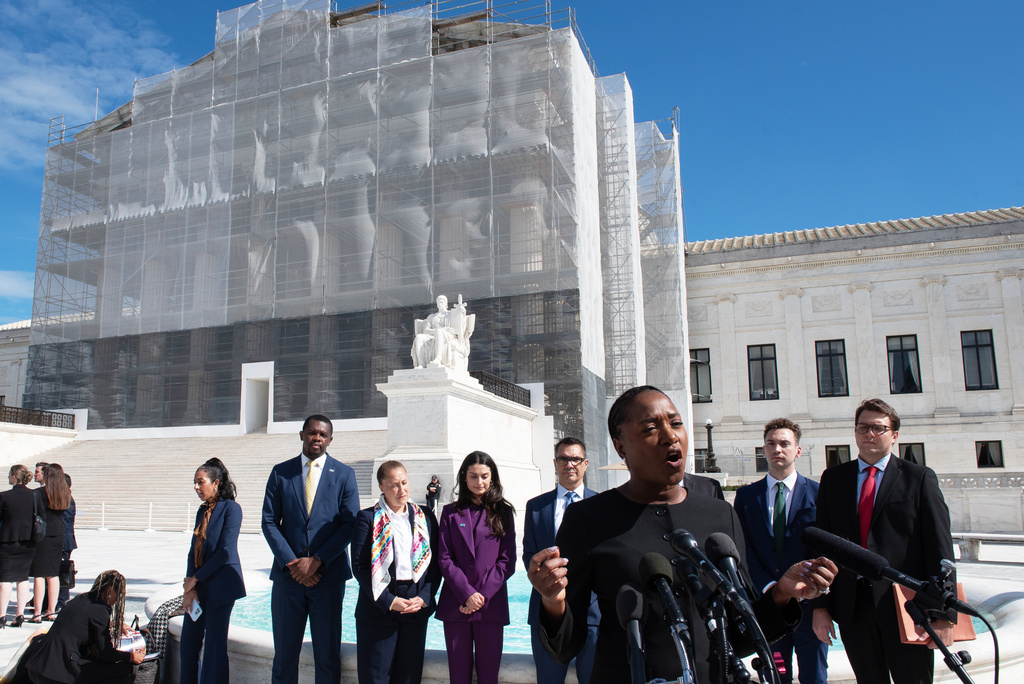 Janai Nelson, front center, president of the NAACP Legal Defense Fund, who was arguing on behalf of a group of Black voters speaks with the news media after departing the court, Wednesday, Oct. 15, 2025, in Washington. (AP Photo/Cliff Owen)
