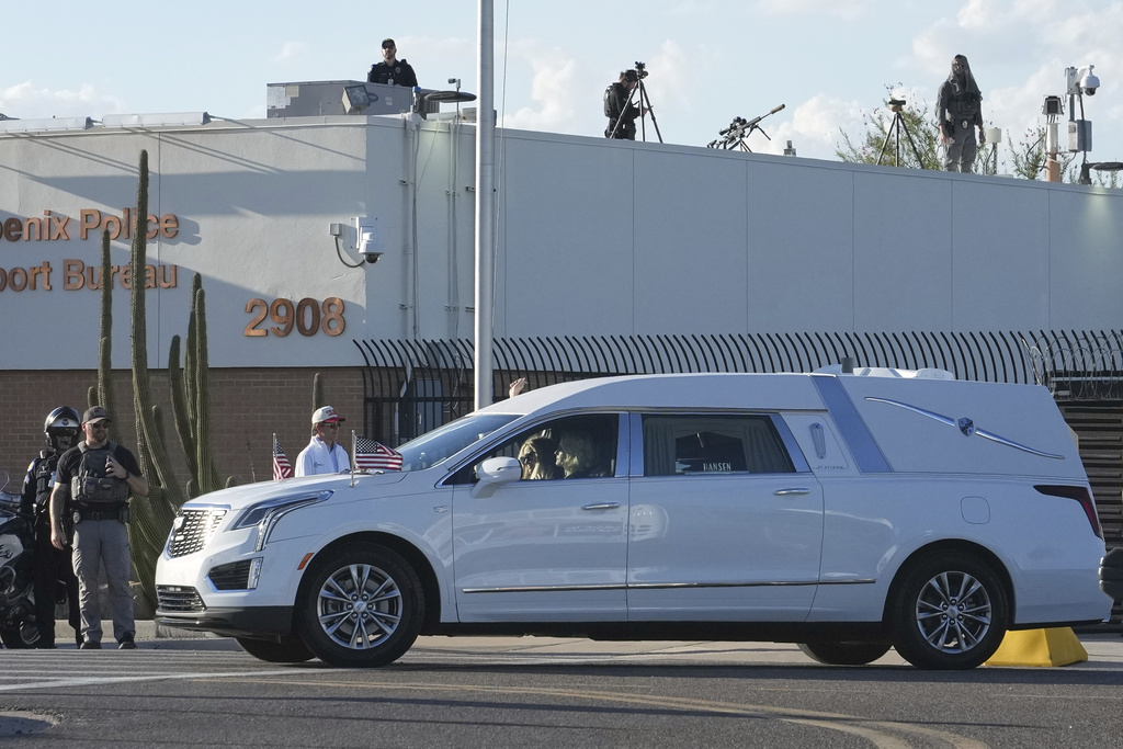 Erika Kirk rides in the passenger seat of a hearse containing the body of Charlie Kirk, the CEO and co-founder of Turning Point USA who was shot and killed on Wednesday as it leaves after being removed from Air Force Two at Phoenix Sky Harbor International Airport, Thursday, Sept. 11, 2025, in Phoenix. (AP Photo/Ross D. Franklin)