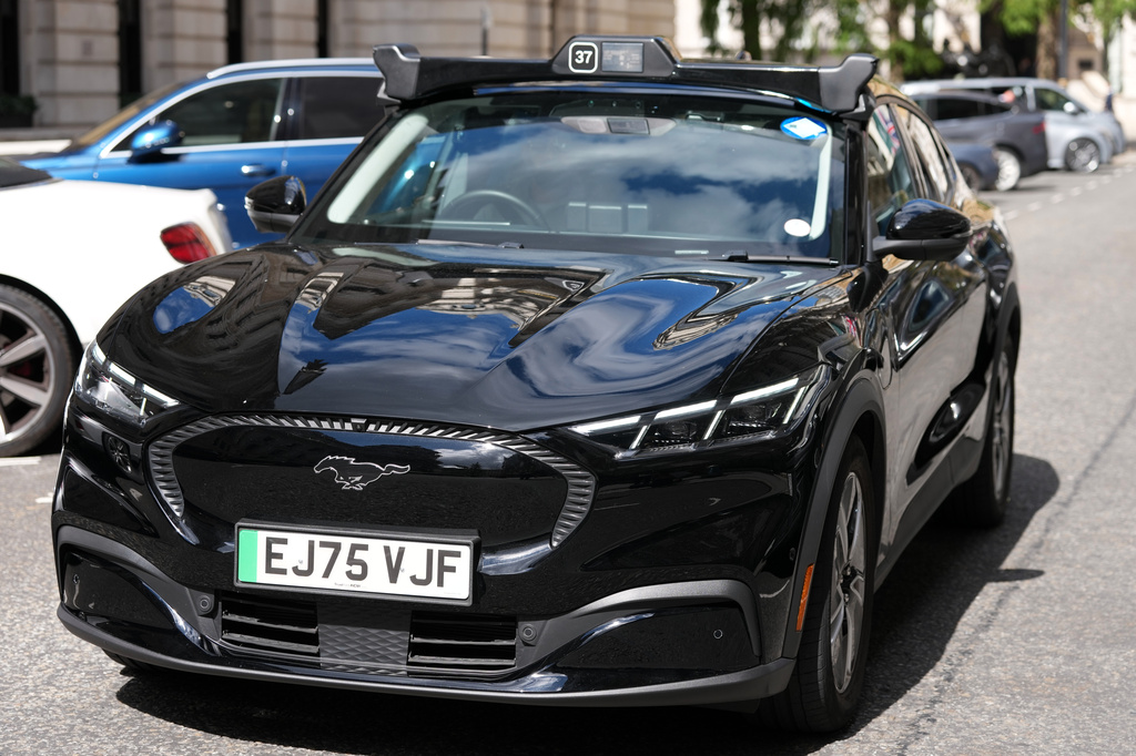 An autonomous car drives through the streets in Westminster, London, Tuesday, Sept. 1, 2026 as Uber officially launches the first hailable autonomous cabs in London.(AP Photo/Frank Augstein)