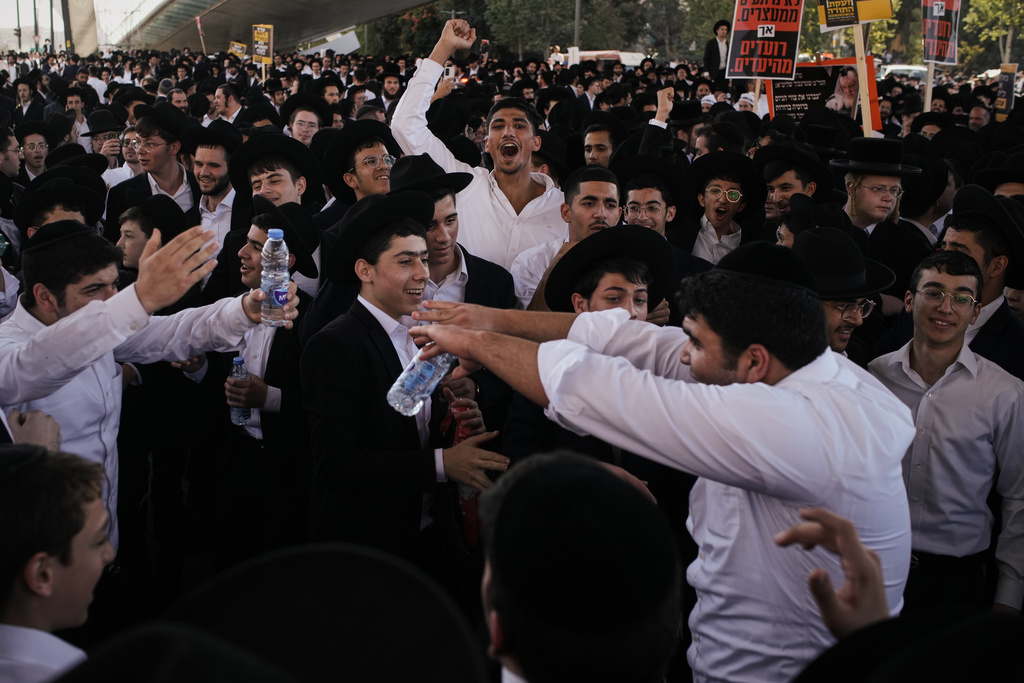 Ultra-Orthodox Jewish men protest against plans to force them to serve in the Israeli military, in Jerusalem, Thursday, Oct. 30, 2025. (AP Photo/Leo Correa)