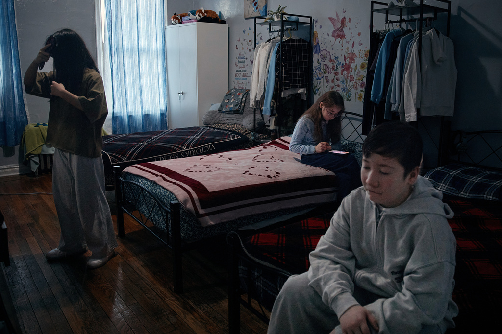 Gulhayo Yuldosheva's children get ready for school in an apartment building where tenants report maintenance issues and pest infestations, in the Bronx borough of New York, Tuesday, March 17, 2026. (AP Photo/Andres Kudacki)