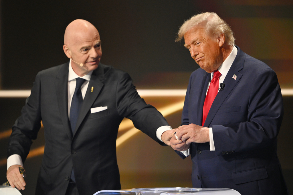 FIFA President Gianni Infantino pauses President Donald Trump during the draw for the 2026 soccer World Cup at the Kennedy Center in Washington, Friday, Dec. 5, 2025. (Mandel Ngan/Pool Photo via AP)