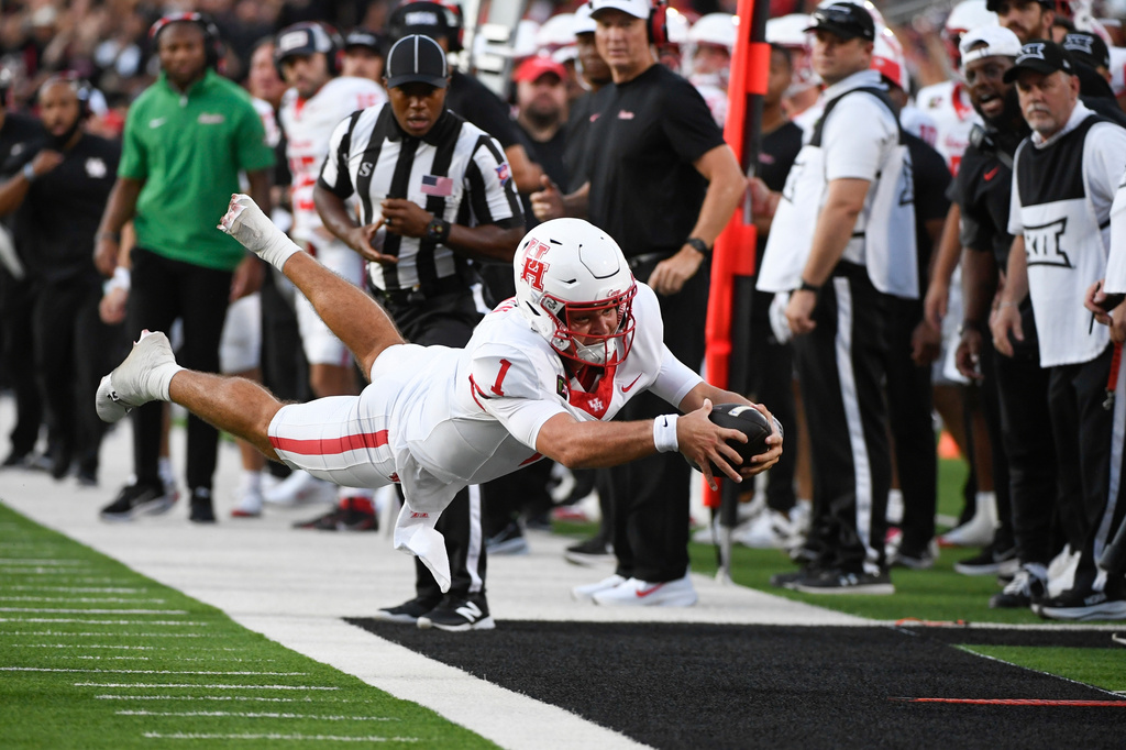 Houston quarterback Conner Weigman (1) leaps out of bounds after running the ball against Texas Tech during the first half of an NCAA college football game Friday, Sept. 18, 2026, in Lubbock, Texas. (AP Photo/Justin Rex)