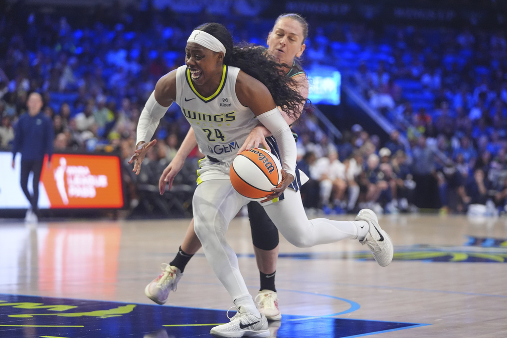 Dallas Wings guard Arike Ogunbowale (24) losses control of her dribble as New York Liberty center Emma Meesseman gets a hand on the ball during the first half of a WNBA basketball game in Arlington, Texas, Friday, Aug. 8, 2025. (AP Photo/LM Otero)
