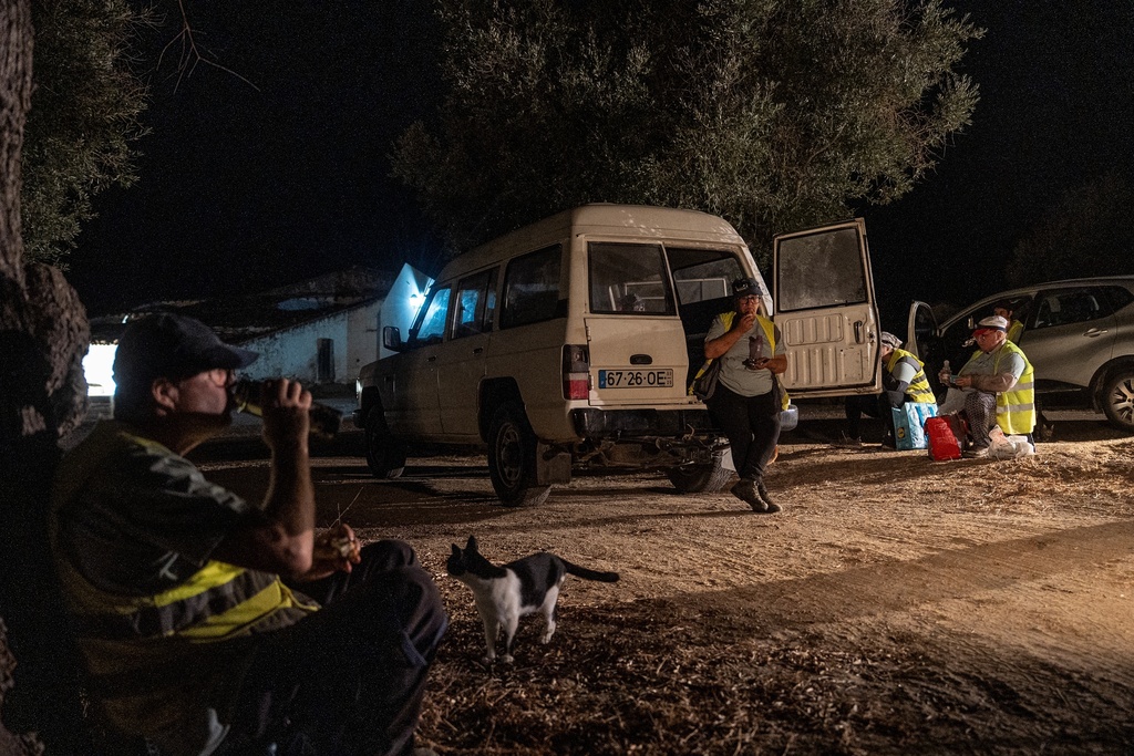 Workers take a break for a meal during a night harvest at the Herdade da Fonte Santa vineyard near Vimieiro, Portugal, Wednesday, Sept. 17, 2025. (AP Photo/Ana Brigida)