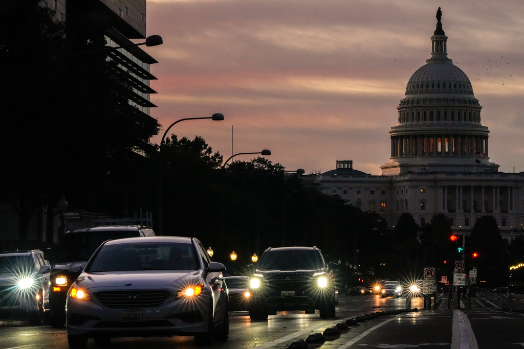 FILE - Vehicles drive along Pennsylvania Ave. during rush hour traffic at sunrise Wednesday, Oct. 1, 2025, in Washington, with the U.S. Capitol in the background. (AP Photo/Julia Demaree Nikhinson, File)