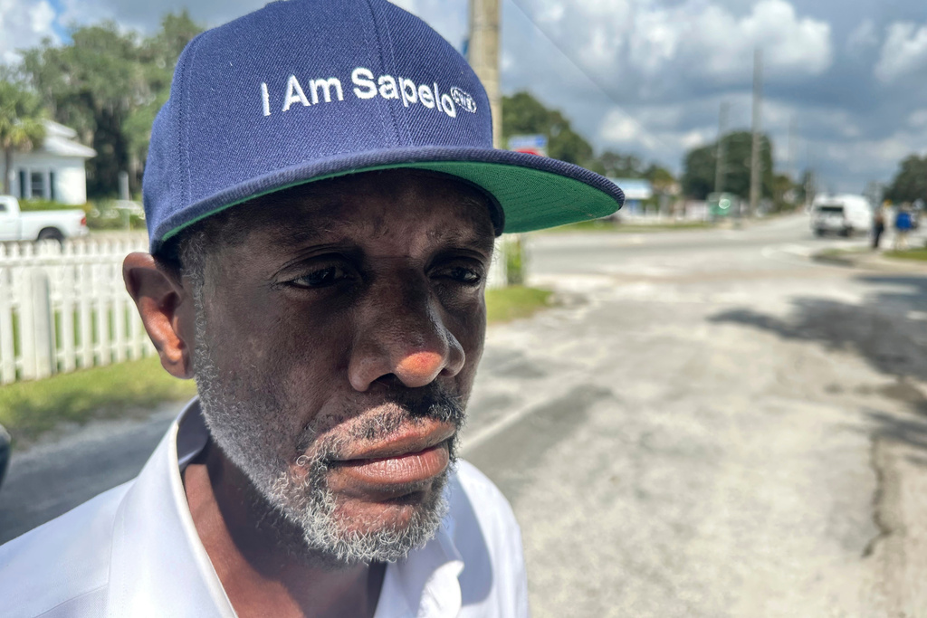 FILE - Jazz Watts, a resident of Sapelo Island, wears a hat that reads "I am Sapelo" outside the McIntosh County courthouse in Darien, Ga., on Friday, Sept. 20, 2024. (AP Photo/Russ Bynum, File)