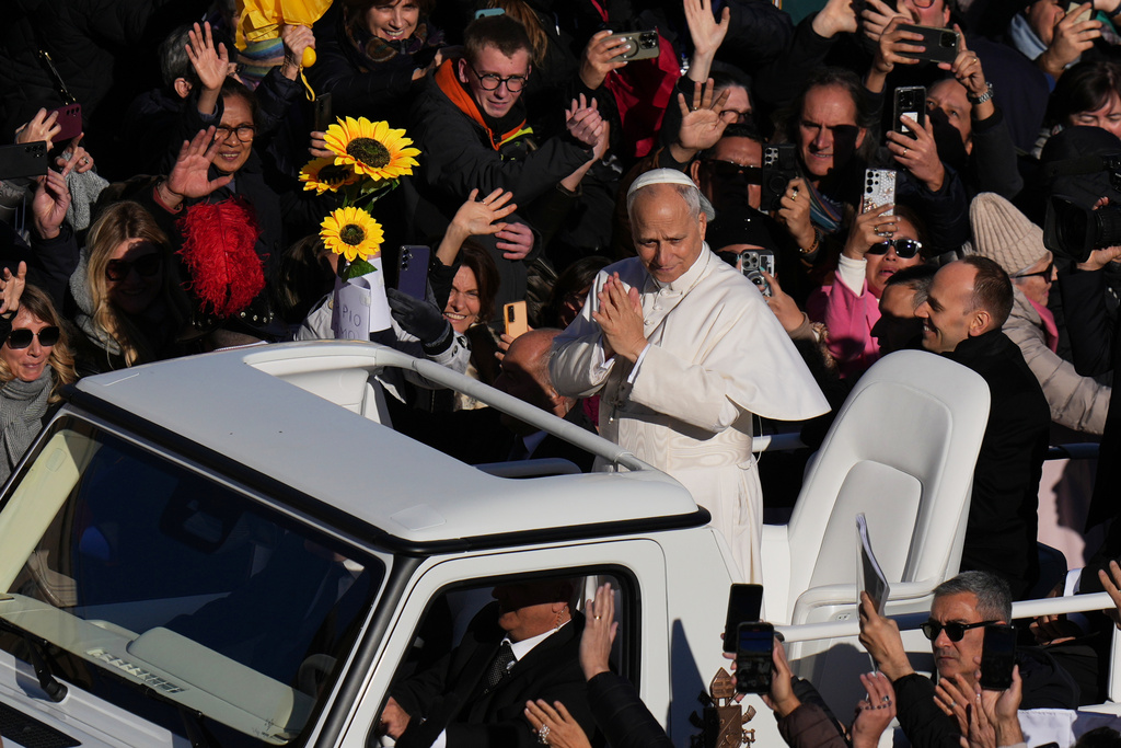Pope Leo XIV waves as he leaves after celebrating a Mass for the Jubilee of the Choirs in St. Peter's Square, at the Vatican, Sunday, Nov. 23, 2025.(AP Photo/Alessandra Tarantino)
