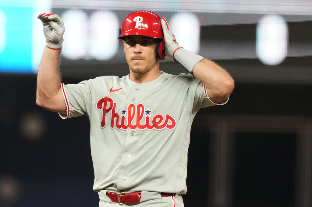 Philadelphia Phillies' J.T. Realmuto reacts after hitting a double to score two runs during the sixth inning of a baseball game against the Miami Marlins, Monday, July 27, 2026, in Miami. (AP Photo/Lynne Sladky)