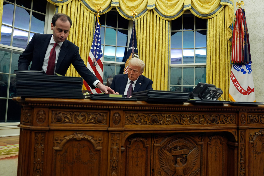 FILE - President Donald Trump signs executive orders in the Oval Office of the White House, Jan. 20, 2025, in Washington. (AP Photo/Evan Vucci, File)