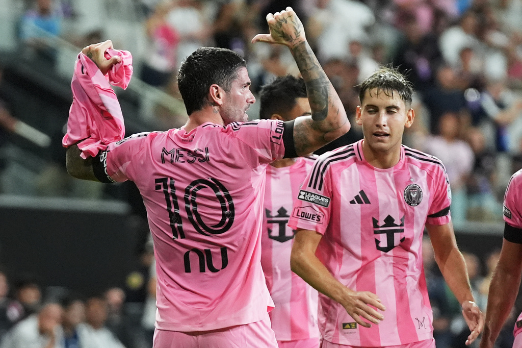 Inter Miami midfielder Rodrigo de Paul, left, celebrates after scoring a goal, wearing the shirt of teammate Lionel Messi (10) who did not play due to death of his father, during the first half of a Leagues Cup soccer match against Monterrey, Saturday, Aug. 8, 2026, in Miami. (AP Photo/Lynne Sladky)