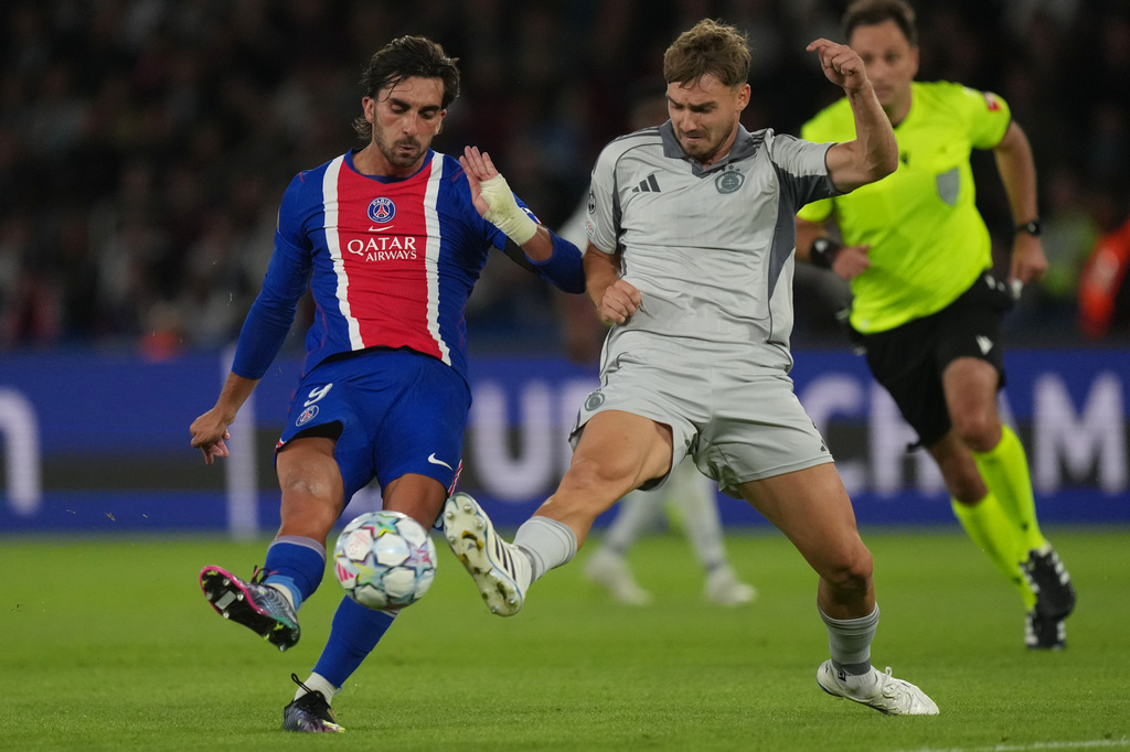 PSG's Ferran Torres, left, challenges with Slovan's Peter Pokorny during the Champions League opening phase soccer match between PSG and Slovan Bratislava in Paris, Wednesday, Sept. 9, 2026. (AP Photo/Thibault Camus)