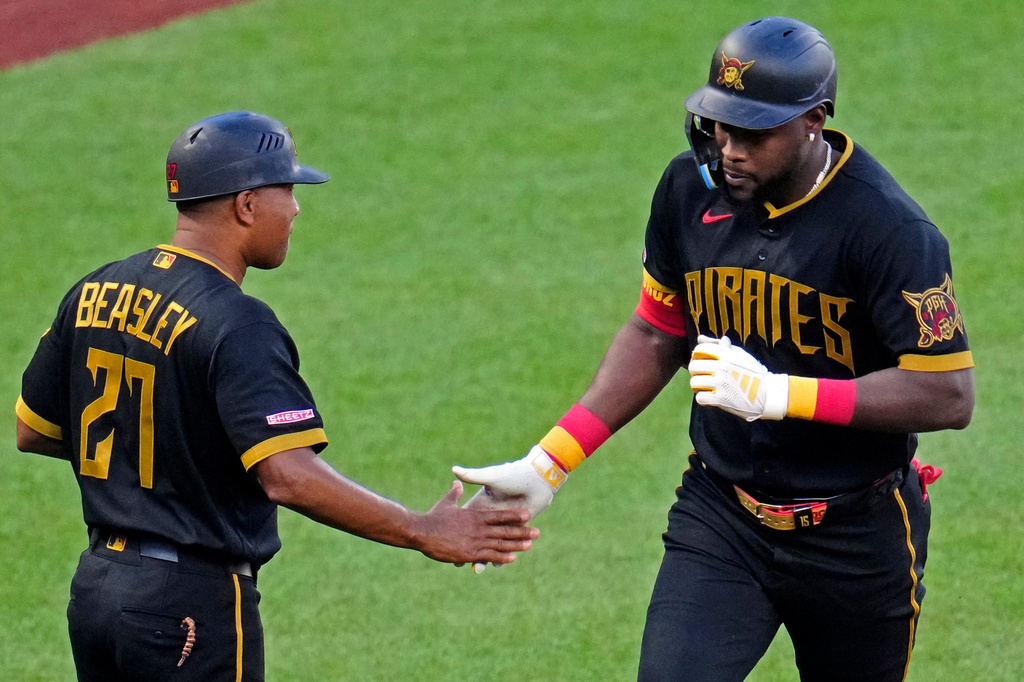 Pittsburgh Pirates' Oneil Cruz, right, is greeted by third base coach Tony Beasley, left, as he rounds third after hitting a solo home run off Minnesota Twins pitcher Taj Bradley during the third inning of a baseball game in Pittsburgh, Friday, May 29, 2026. (AP Photo/Gene J. Puskar)