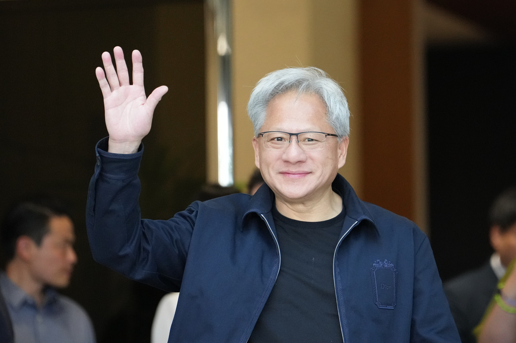 Nvidia CEO Jensen Huang waves upon his arrival at the Gimpo Airport in Seoul, South Korea, Friday, June 5, 2026. (AP Photo/Lee Jin-man)