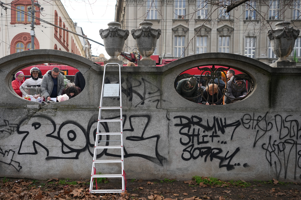 Serbia's protesting university students collect signatures for their request for an early parliamentary election, in Belgrade, Serbia, Sunday, Dec. 28, 2025. (AP Photo/Darko Vojinovic)