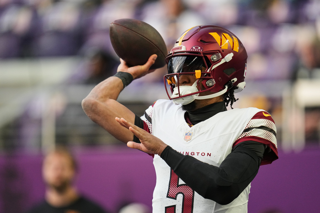 Washington Commanders quarterback Jayden Daniels warms up before an NFL football game against the Minnesota Vikings, Sunday, Dec. 7, 2025, in Minneapolis. (AP Photo/Abbie Parr)