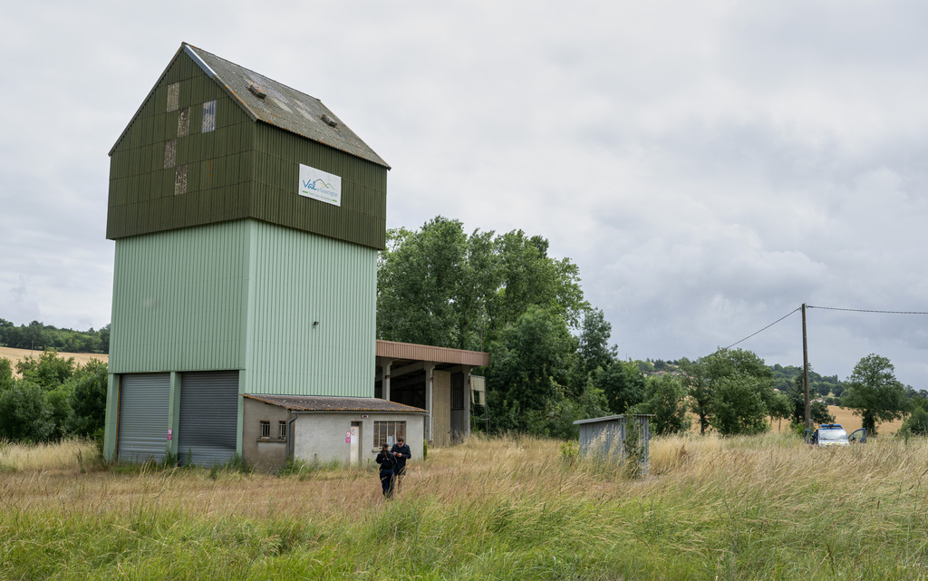 French police guard a farm silo where a body was found yesterday during the search to find missing 11 year-old girl Lyhanna in Puycasquier, southwestern France, Friday, June,5, 2026. (AP Photo/Frederic Lancelot)