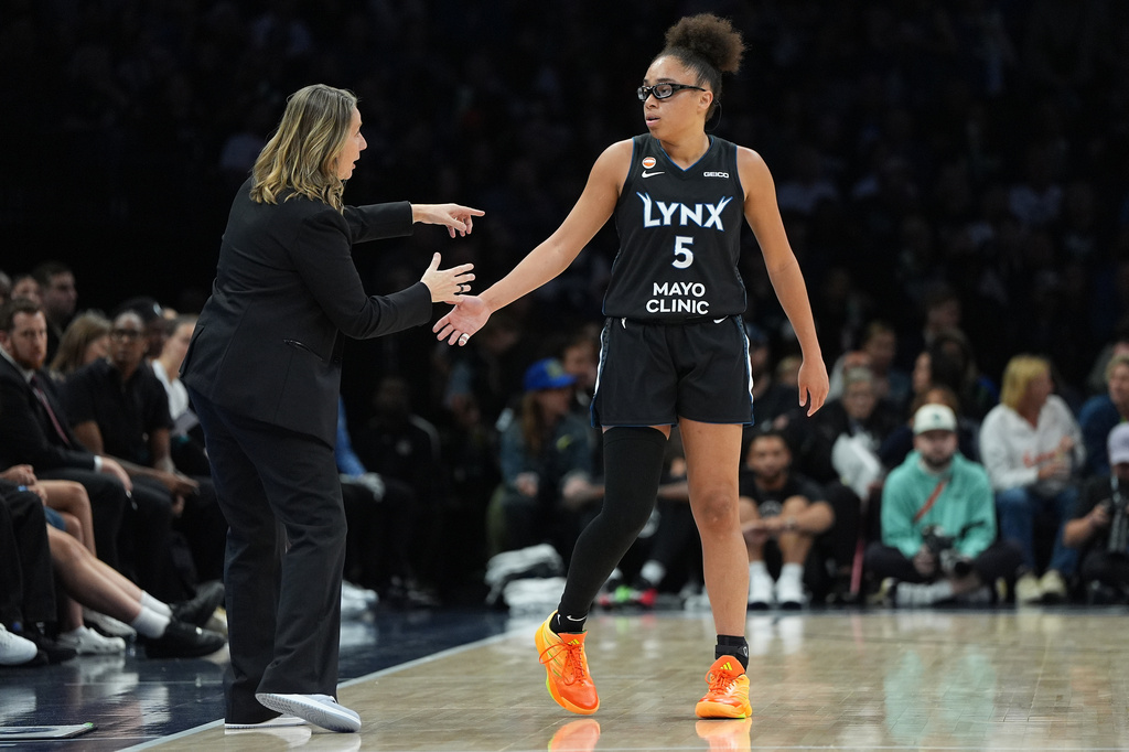 Minnesota Lynx head coach Cheryl Reeve and guard Olivia Miles (5) talk during the first half of a WNBA basketball game against the New York LibertyFriday, Sept. 18, 2026, in Minneapolis. (AP Photo/Abbie Parr)