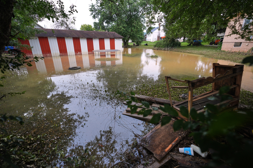 Flood waters cover several yards in Crooksville, Ohio, Wednesday, Aug. 12, 2026. (AP Photo/Gene J. Puskar)