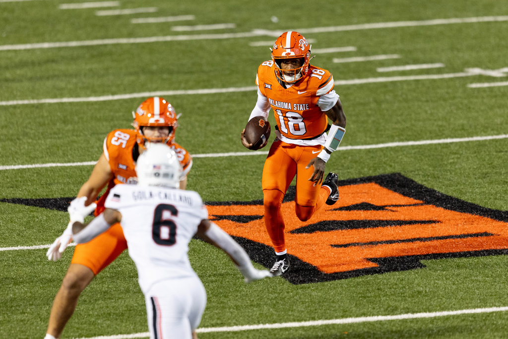 Oklahoma State quarterback Sam Jackson V (18) runs the ball in the first half of an NCAA college football game against Cincinnati, Saturday, Oct. 18, 2025, in Stillwater, Okla. (AP Photo/Mitch Alcala)