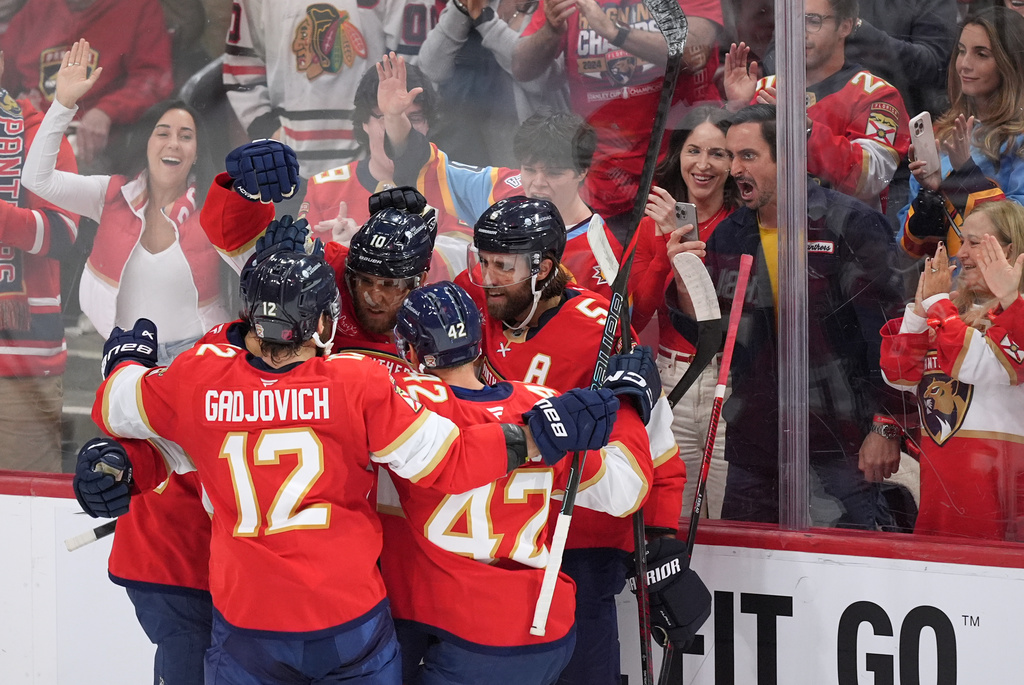 Florida Panthers left wing A.J. Greer (10) celebrates scoring the team's first goal against the Chicago Blackhawks along with teammates including defenseman Aaron Ekblad (5), during the first period of an NHL hockey game, Tuesday, Oct. 7, 2025, in Sunrise, Fla. (AP Photo/Rebecca Blackwell)