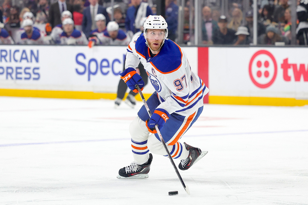 Edmonton Oilers center Connor McDavid moves the puck during the first period of an NHL hockey game against the Los Angeles Kings, Saturday, April 11, 2026, in Los Angeles. (AP Photo/Ryan Sun)
