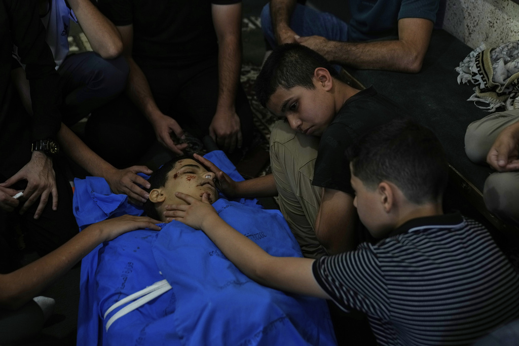 Qassam, 11, center takes the last look at his brother Islam Majarmeh, one of two 14-year-old Palestinian boys who were killed in the Jenin refugee camp on Monday, during his funeral in the Israeli occupied West Bank city of Jenin Tuesday, Sept. 9, 2025. (AP Photo/Nasser Nasser)